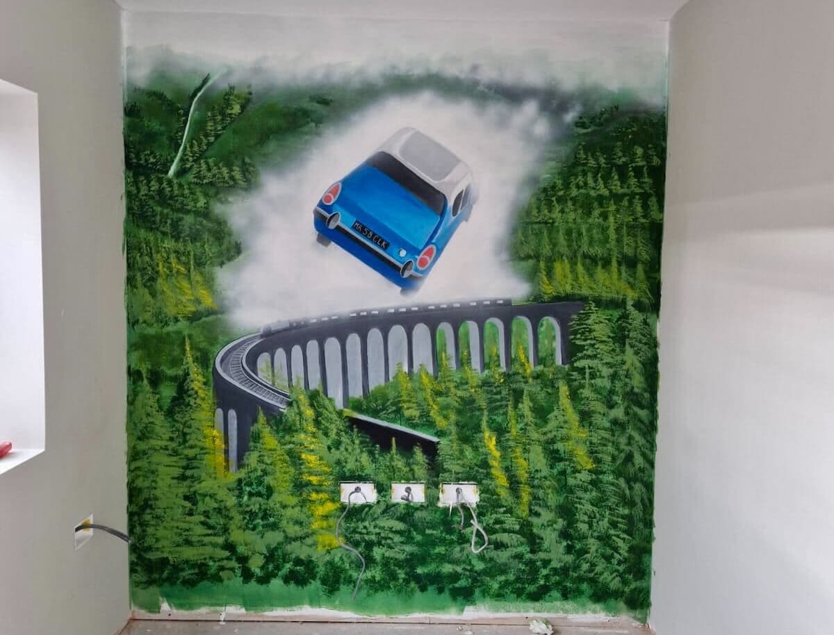 Harry Potter inspired mural with flying Ford Anglia and steam train